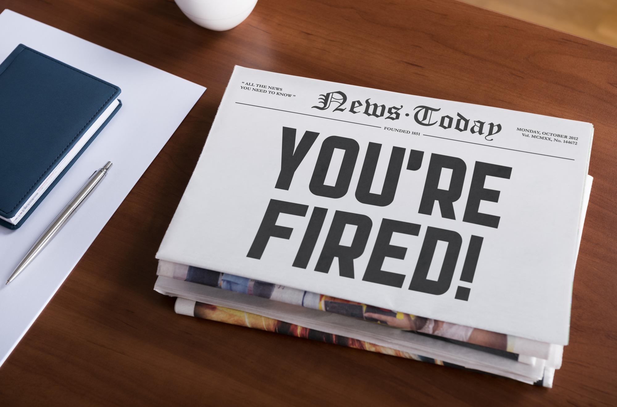 Newspaper on desk with words "News Today, You're Fired!"